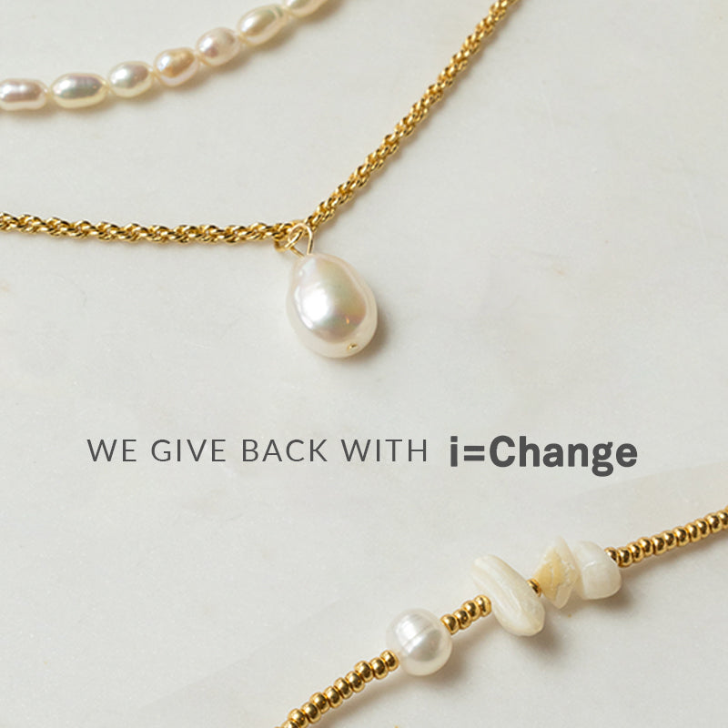 Three Arms Of Eve necklaces with the words 'we give back' and 'i = change' symbolizing our commitment to making a difference