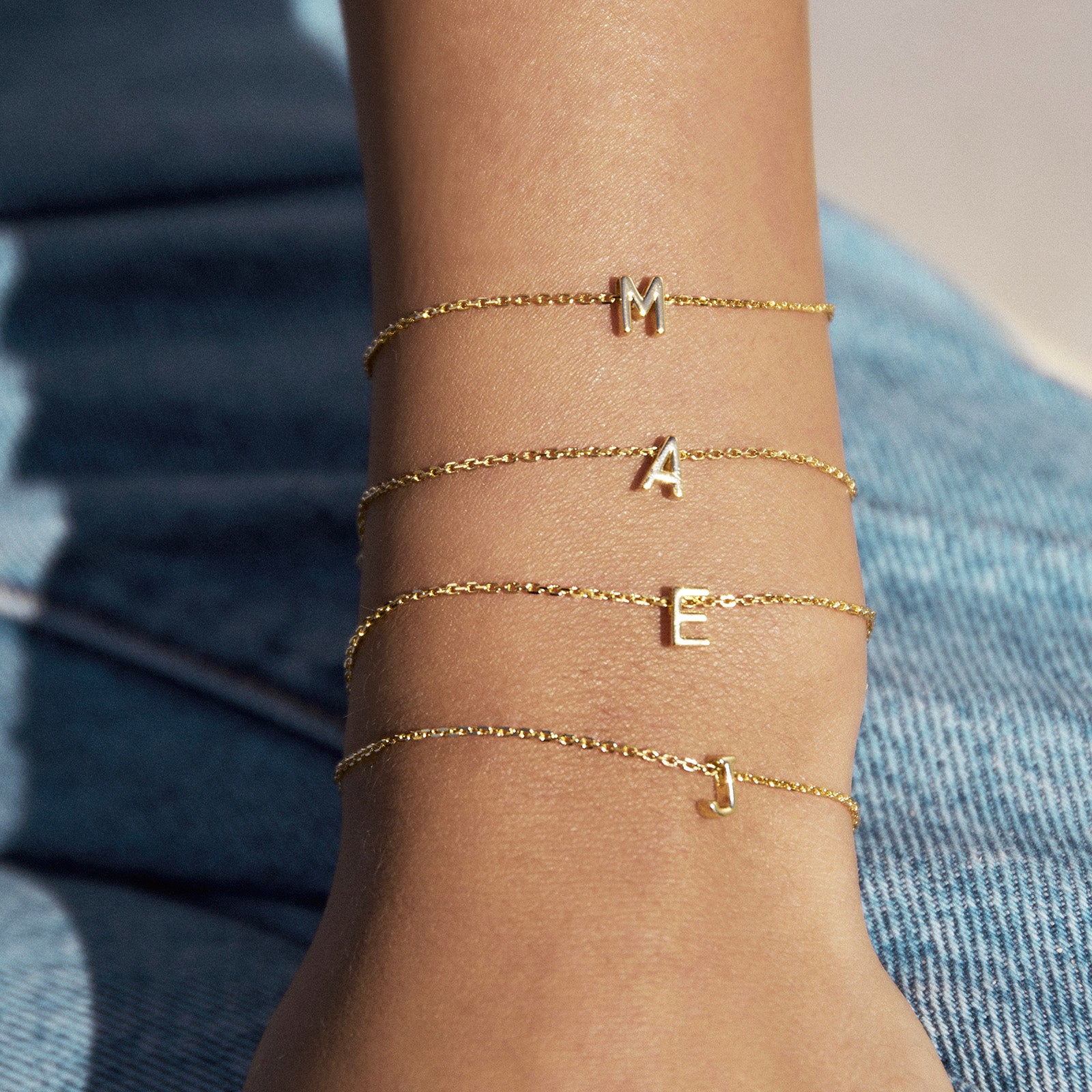Arms Of Eve Say My Name gold chain bracelet with a charm in the shape of a letter A