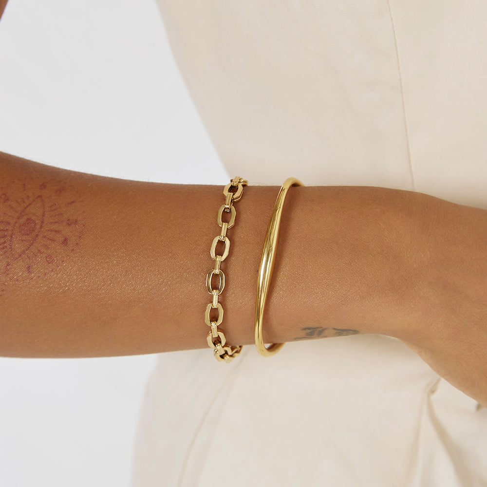 Arms Of Eve Madison gold cuff bracelet with a curved end, exuding elegance and style