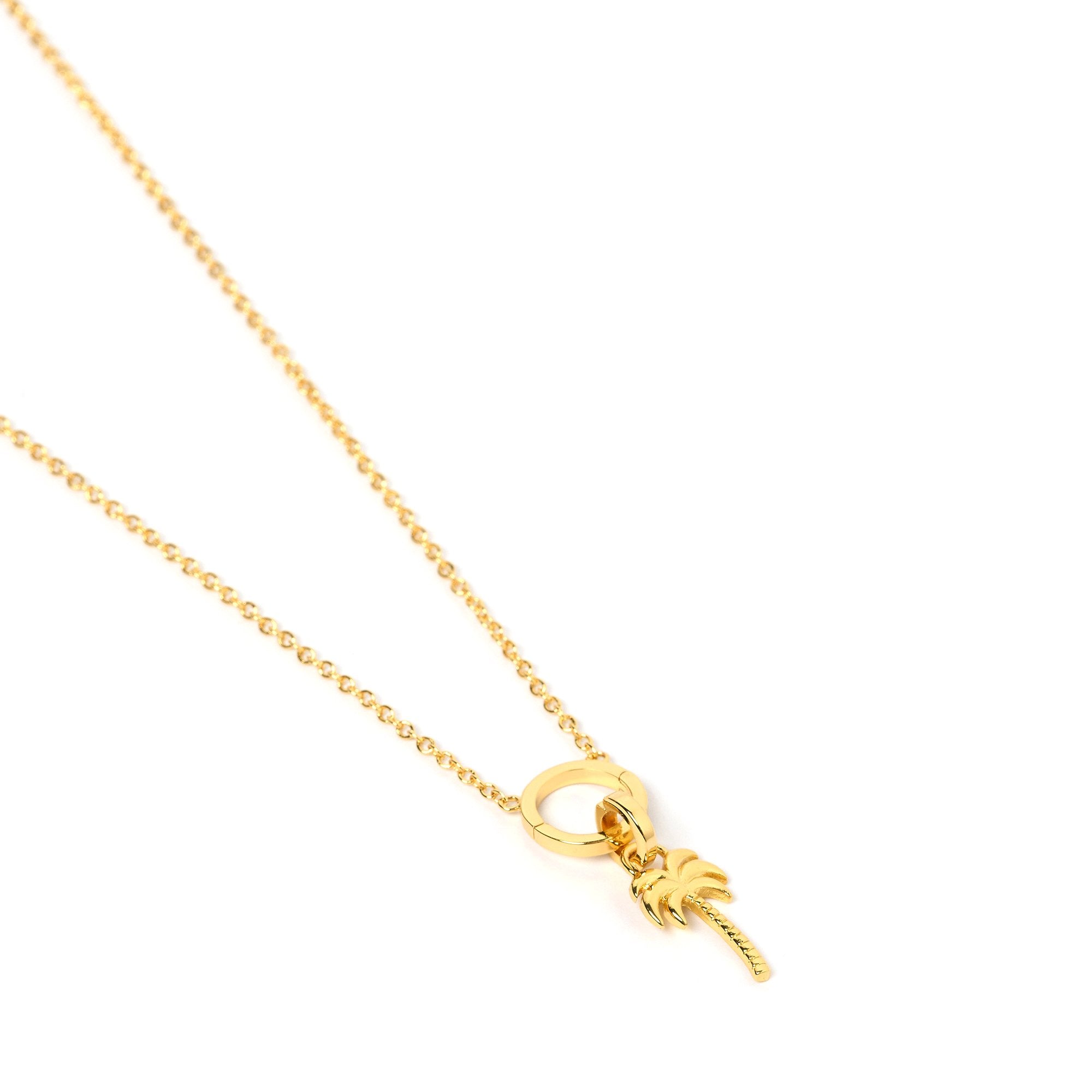 Arms Of Eve Palm Springs 'O' charm gold necklace featuring palm tree pendant, adding touch of tropical charm to any outfit